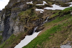An Alpine stream disappearing under the snow